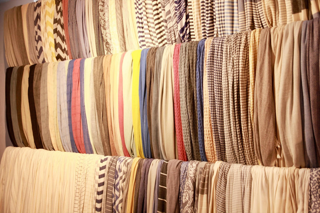Rows of towels in many colours hanging in a mill showroom in Turkey