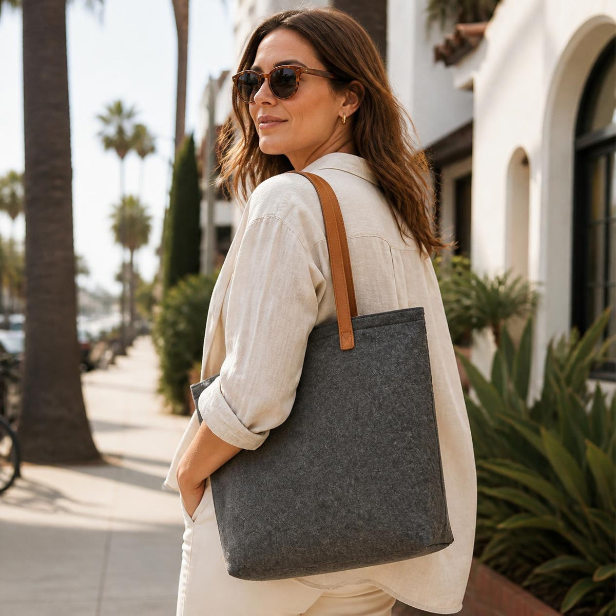 Charcoal Bellagio wool tote carried on a sunny city street