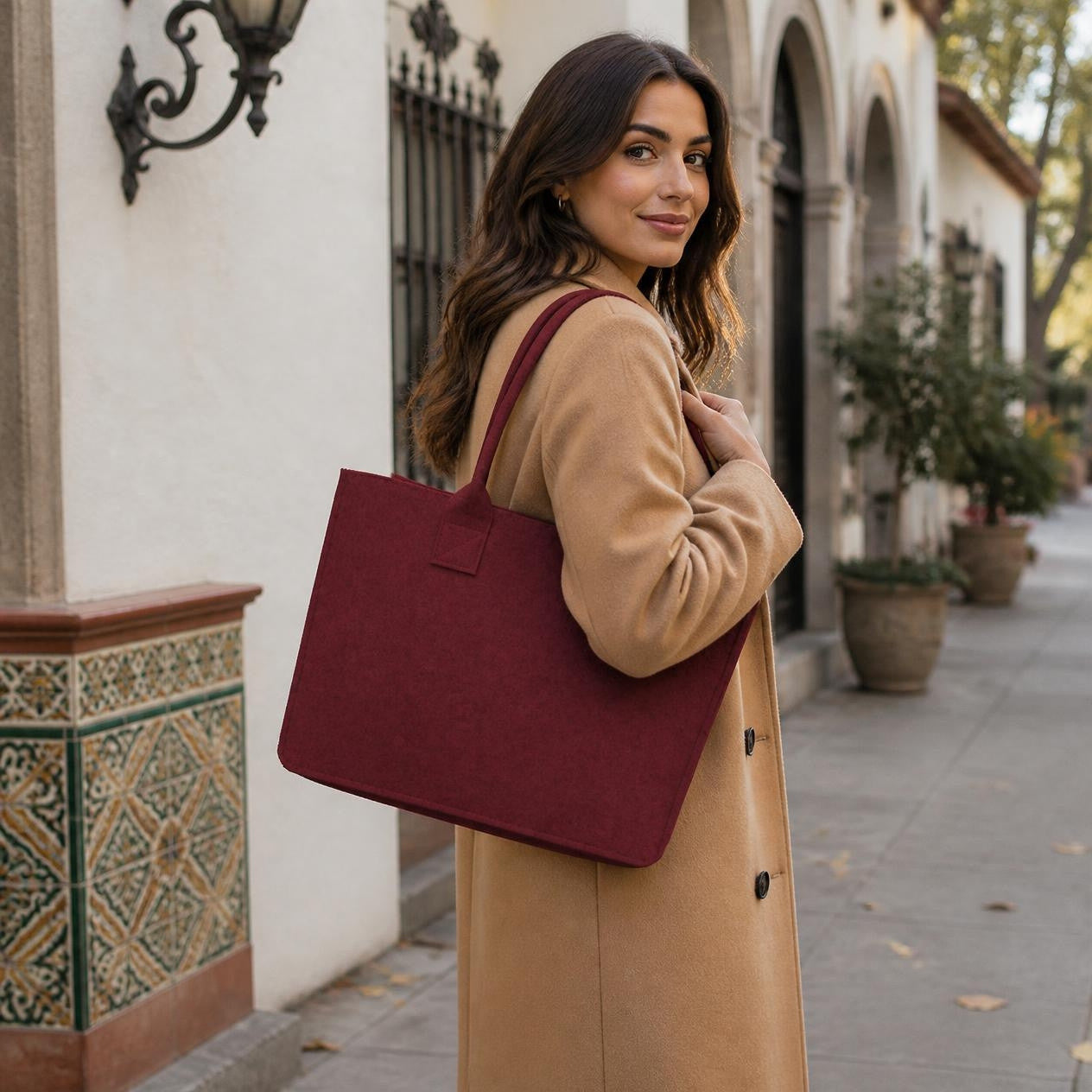 Burgundy Portofino felt tote on a city street
