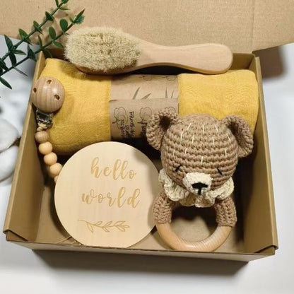 Baby gift set with toys and a blanket in a box on a white background
