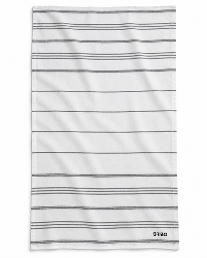 A white cotton towel with thin horizontal gray stripes and a small black BRIZO logo printed in the bottom right corner, shown flat against a white background.
