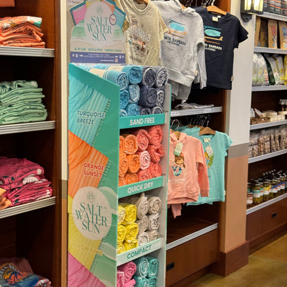 Display of towels and travel supplies in an airport gift shop