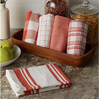 Set of red and white checkered towels on a wooden tray with kitchen items in the background.