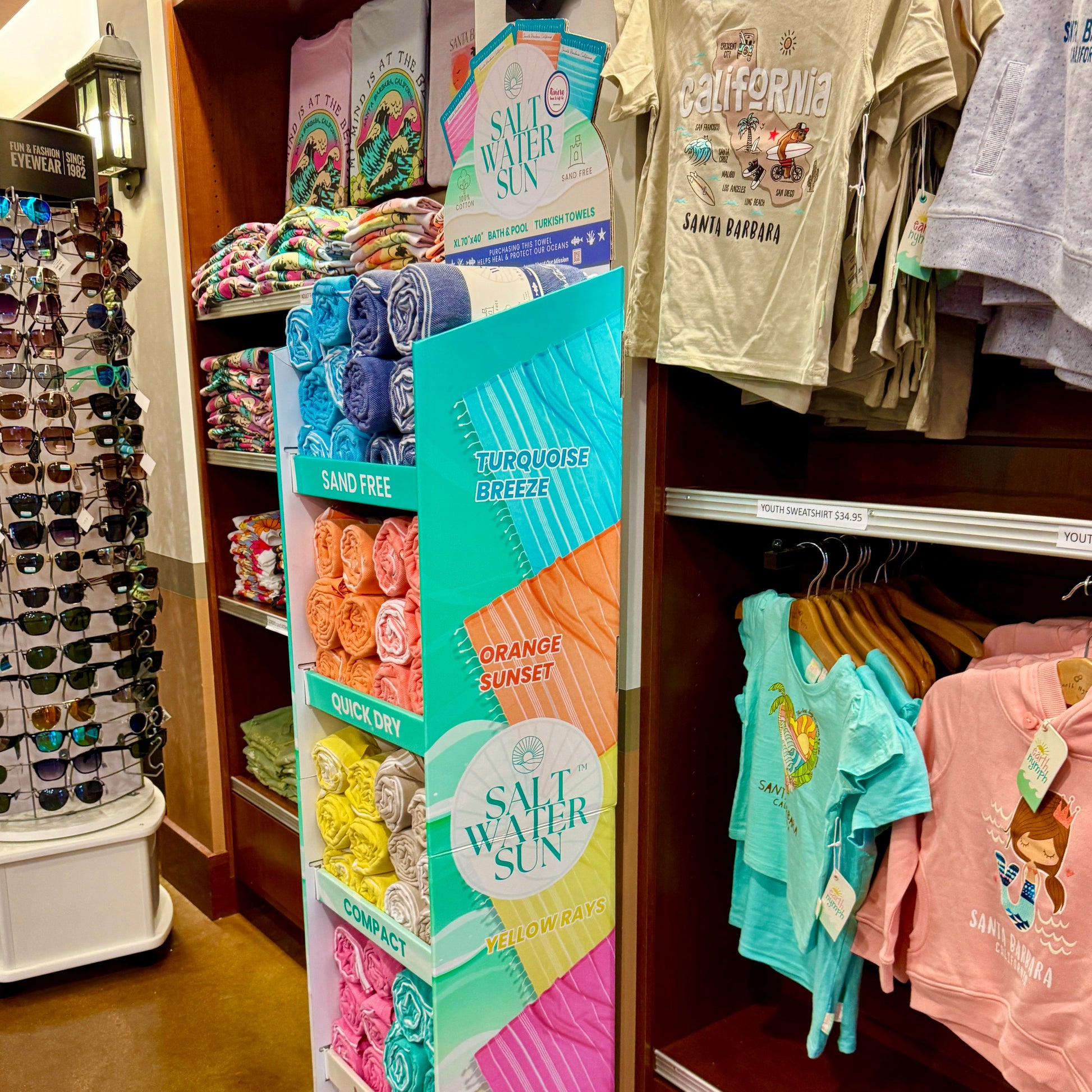 Display of children's clothing and travel towels and accessories in an airport travel shop