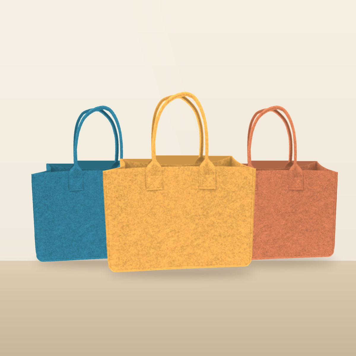 Ocean Blue, Mustard and Terracotta Portofino felt totes on a warm sand backdrop